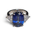 Oval Cut Lab Grown Blue Sapphire and Trilliant Accent Lab Grown Diamond Ring in 14 Karat White Gold