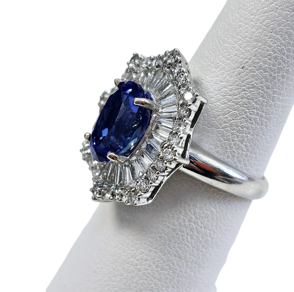 Oval Tanzanite with Diamond Baguette and Round Brilliant Cut Ballerina Skirt made in 18-Karat White Gold
