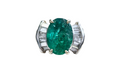 Oval-Cut Emerald and Bow Tie Style Baguette Cut Diamond Ring made in 14-Karat Yellow and White Gold