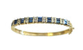Circa 1980 Sapphire and Diamond Bangle Bracelet in 14 Karat Yellow Gold