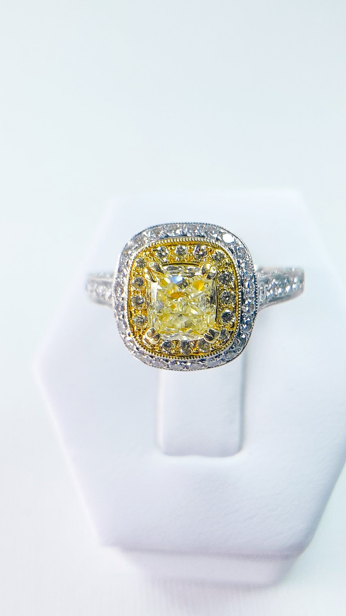 Ring, Fancy Yellow Cushion Cut Center Diamond w/ pave set round side diamonds, in 18kt yellow/white gold